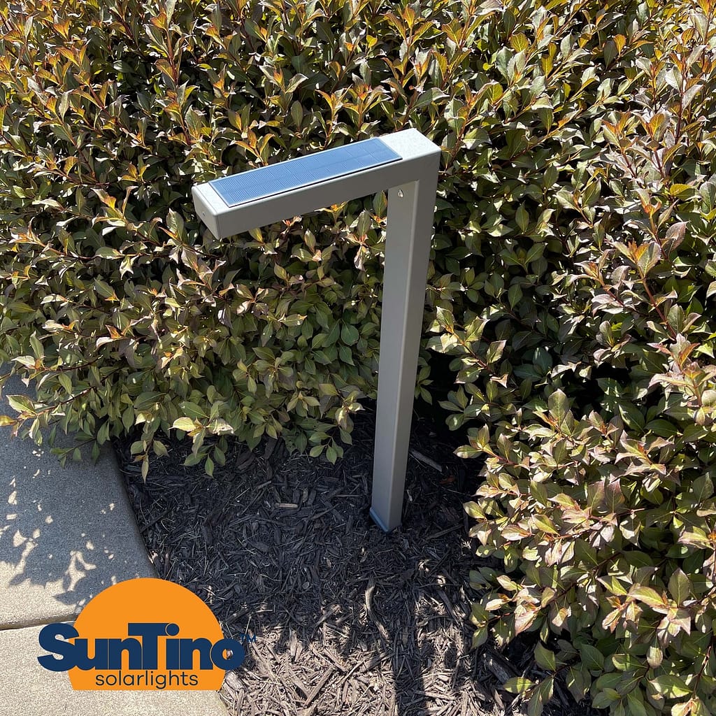 A metal post with outdoor solar lights in front of it.