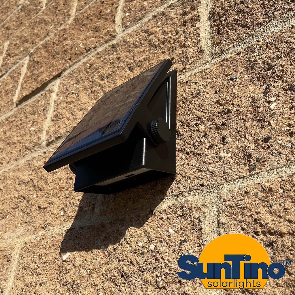 A premium SOLAR FLOOD- Wall Pack mounted on the side of a brick wall.