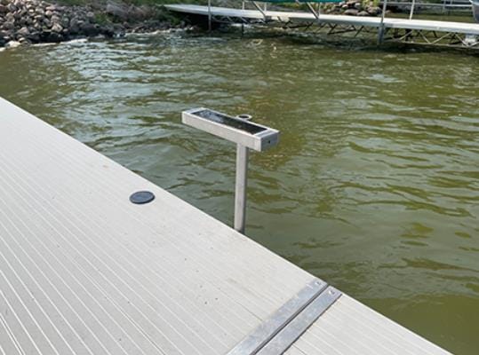 An outdoor dock with a solar light on top of it.